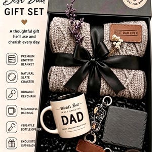 May include: A gift set in a black magnetic closure box containing a grey cable-knit blanket with a brown leather patch reading BEST DAD EVER, a white ceramic mug with the text World's Best TRULY AMAZING DAD, a square slate coaster, and a keychain.