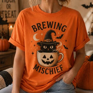 Brewing Mischief Halloween Shirt | Black Cat Pumpkin Coffee Tee | Cute Witch Cat T-Shirt | Fall Coffee Lover Gift | Spooky Season Tee