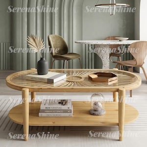 May include: An oval wooden coffee table with a glass top featuring a sunburst-patterned base. The table has a lower shelf holding three stacked books titled Abstract Form, MCM Furniture, and New Nordic, plus a glass dome with a white sphere.