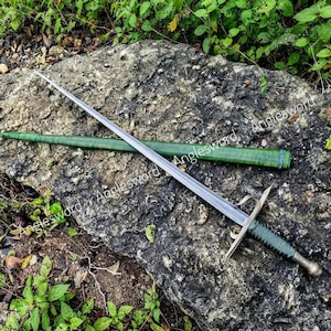 May include: A steel sword with a long, straight blade and a crossguard featuring curved quillons. The handle is wrapped in dark green cord, and it is accompanied by a matching green scabbard with a textured finish and a blue-wrapped collar.