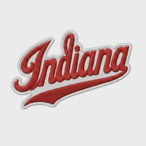 May include: An embroidered patch featuring the word Indiana in a red cursive script font. The lettering is outlined in white thread and includes a long red underline swoosh that extends from the final letter back toward the beginning.