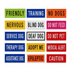 May include: A collection of fifteen rectangular dog harness patches in various colors, each featuring bold black or white text. The labels include Friendly, Training, No Dogs, Nervous, Blind Dog, Do Not Feed, Service Dog, Deaf Dog, Do Not Pet, Therapy Dog, Adopt Me, Medical Alert, Assistance Dog, Epileptic, and Caution.