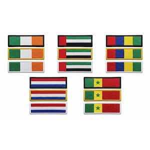 May include: A collection of fifteen rectangular embroidered patches featuring national flag designs. The set includes three patches each for Ireland, the United Arab Emirates, Colombia, the Netherlands, and Senegal, all with stitched borders.