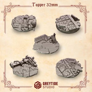 May include: Five circular grey resin miniature base toppers measuring 32mm in diameter. Each piece features detailed textures including cracked stone tiles, floral carvings, debris, and architectural ruins. The text Topper 32mm is visible at the top.