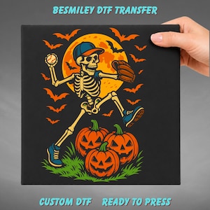 May include: A DTF transfer featuring a skeleton wearing a baseball cap and glove, throwing a baseball in front of a large yellow moon. The design includes orange bats, three jack-o'-lanterns on green grass, and the text BESMILEY DTF TRANSFER.