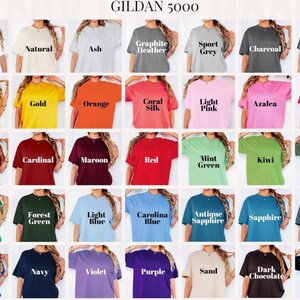 May include: A grid of Gildan 5000 t-shirts in various colors including white, natural, ash, graphite heather, sport grey, charcoal, dark heather, daisy, gold, orange, coral silk, light pink, azalea, heliconia, antique cherry red, cardinal, maroon, red, mint green, kiwi, military green, irish green, forest green, light blue, carolina blue, antique sapphire, sapphire, indigo blue, royal, navy, violet, purple, sand, dark chocolate, and black.