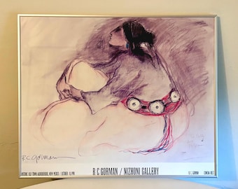 May include: A framed art print featuring a charcoal and ink sketch of a seated figure wearing a concha belt. The print includes the text R C GORMAN / NIZHONI GALLERY, HISTORIC OLD TOWN, ALBUQUERQUE, NEW MEXICO / OCTOBER 10, 1998, and R C GORMAN CONCHA BELT.