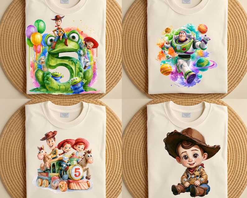 May include: Four off-white t-shirts featuring colorful Toy Story character graphics. One shows a large green number five with Woody, Jessie, and aliens. Another features Buzz Lightyear with planets. A third shows characters on a train. One shows a young cowboy.