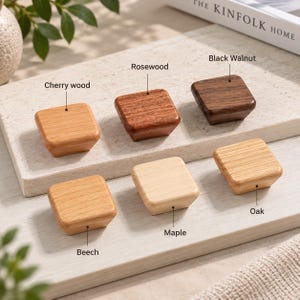 May include: Six square wooden cabinet knobs in various wood types, labeled as Cherry wood, Rosewood, Black Walnut, Beech, Maple, and Oak. Each knob features a smooth, tapered design with distinct natural wood grain patterns and color variations.