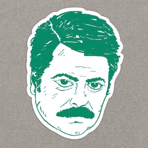 May include: A die-cut sticker featuring a green and white line-art illustration of a person with a thick moustache and short hair. The design uses a sketch-like style with green ink on a white background, capturing a serious facial expression.