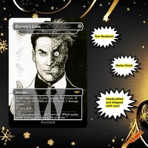 May include: A rectangular game card titled Harvey's Coin featuring a black and white illustration of a man with a split face. The card text includes Mana Crypt, Artifact, and a quote about justice. Three starburst icons list Tear Resistant, Matte Finish, and Handcrafted and shipped with care.