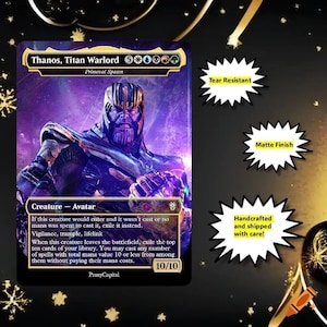 May include: A rectangular trading card featuring Thanos, Titan Warlord with purple and gold cosmic artwork. The card displays text including Creature-Avatar, 10/10, and game rules. Three white starburst labels indicate Tear Resistant, Matte Finish, and Handcrafted.