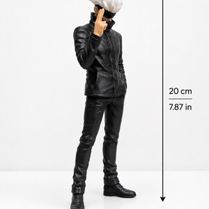 May include: A standing anime character figurine with spiky white hair, a black blindfold, and a black high-collar jacket with matching trousers and boots. The figure is 7.87 inches tall, shown with a vertical measurement line indicating the height.