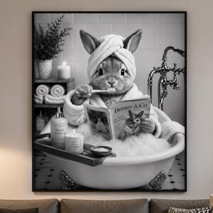 May include: A black and white wall art print featuring a rabbit in a bathtub wearing a towel on its head, brushing its teeth, and reading a magazine titled Bunny & Co. The scene is set in a tiled bathroom with a clawfoot tub and bath accessories.
