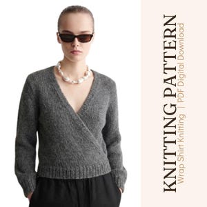 May include: A dark grey long-sleeve knit wrap sweater with a V-neckline and ribbed cuffs and hem. The text on the right side reads KNITTING PATTERN Wrap Shirt Knitting | PDF Digital Download. The sweater is worn with a white beaded necklace.