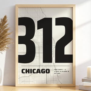 May include: A framed wall art print featuring a large black number 312 over a light gray street map of Chicago. The text CHICAGO is printed below the number, followed by Cook County, IL, coordinates 41.8781 N, 87.6298 W, and EST. 1833.