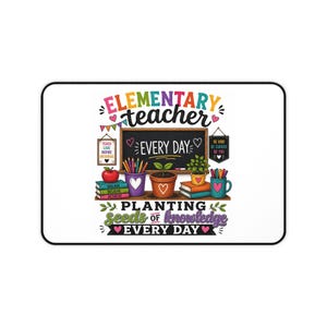 May include: A rectangular desk mat featuring a colorful illustration of a classroom scene with a chalkboard, books, potted plants, and pencils. The text reads "ELEMENTARY teacher EVERY DAY" and "PLANTING SEEDS OF KNOWLEDGE EVERY DAY" with small hearts.
