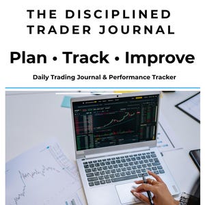 May include: The Disciplined Trader Journal, Plan • Track • Improve, Daily Trading Journal & Performance Tracker. A silver laptop displays stock market charts, accompanied by printed financial graphs and a notebook on a white desk.