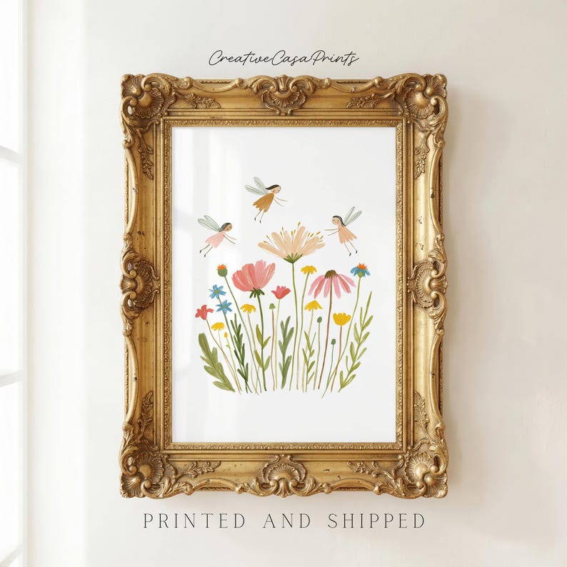 May include: A vertical rectangular wall art print featuring a whimsical illustration of colorful wildflowers and three small fairies in flight, enclosed within an ornate, antique-style gold frame with intricate carved detailing along the edges.