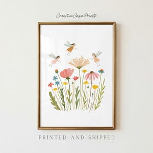 May include: A framed art print featuring a white background with a colorful illustration of various wildflowers in shades of pink, yellow, and blue, accompanied by three small winged figures. The text Creative Casa Prints is at the top.