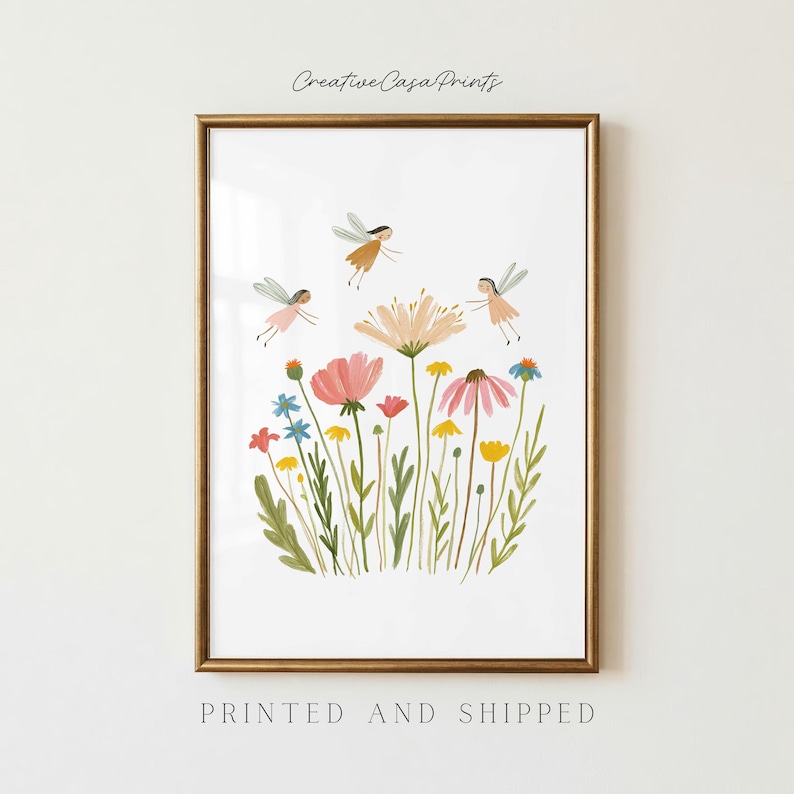 May include: A framed art print featuring a white background with a colorful illustration of various wildflowers in shades of pink, yellow, and blue, accompanied by three small winged figures. The text Creative Casa Prints is at the top.
