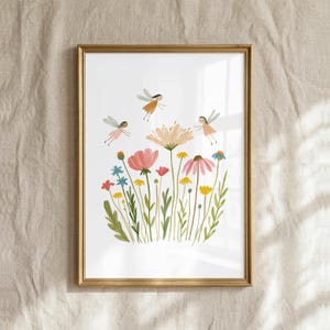 May include: A framed art print featuring a white background with a colorful illustration of various wildflowers in shades of pink, yellow, orange, and blue, accompanied by two small winged fairy figures flying above the floral arrangement.