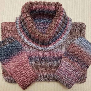 May include: A striped knit turtleneck sweater with matching fingerless gloves. The sweater and gloves are a mix of pink, brown, and gray.