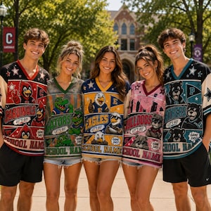 May include: Five short-sleeved V-neck jerseys featuring various team mascots, including a cardinal, alligator, eagle, bulldog, and panther. Each jersey displays the team name, the phrase 'LET'S GO!', and a placeholder for a school name.