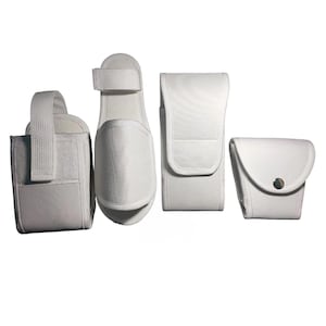 May include: A set of four white accessories including a rectangular pouch with a vertical strap, a flat slipper-like item with a hook-and-loop closure, a tall rectangular case with a flap, and a small square pouch with a single metal snap button.