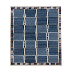 May include: A rectangular area rug featuring a grid of alternating dark and medium blue blocks. The design includes vertical columns of small, light-colored diamond patterns and a border composed of alternating dark blue and maroon rectangular segments.