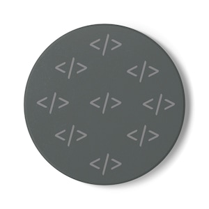 May include: A circular dark gray coaster featuring a repeating pattern of light gray coding bracket symbols. The design consists of multiple sets of angle brackets arranged in a grid-like formation across the flat, matte surface of the object.