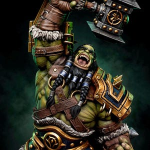 May include: A 1/6 scale green-skinned orc figurine with a dark beard, wearing brown leather straps, fur-trimmed armor, and gold-accented pauldrons. The orc holds a large metal hammer overhead. Text includes "PRESUPPORTED TESTED", "SCALE 1/6", and "WICKED".