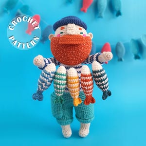 May include: A crocheted doll of a bearded sailor wearing a dark blue cap and a white and blue striped shirt with teal shorts. The figure holds five small, multi-colored crocheted fish. The text CROCHET PATTERN is printed in a white circle.