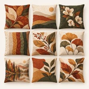 May include: A collection of nine square throw cushions featuring autumn-inspired designs. Patterns include botanical leaves, ginkgo foliage, berries, rolling hills with a sun, a forest landscape by a lake, and abstract shapes in shades of orange, brown, and green.