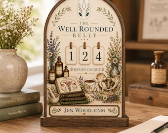 May include: An arched wooden sign featuring the text THE WELL ROUNDED BELLY, 124 BABIES CAUGHT, and JEN WOOD, CNM. The design includes illustrations of lavender, apothecary bottles, a book titled ANATOMY, a teacup, and a human pelvis bone.