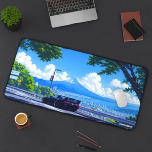 May include: A rectangular desk mat featuring a vibrant anime-style illustration of a black sports car driving on a coastal road with Mount Fuji in the background, under a bright blue sky with white clouds, and the text FORTYSECONDLAP in the corner.