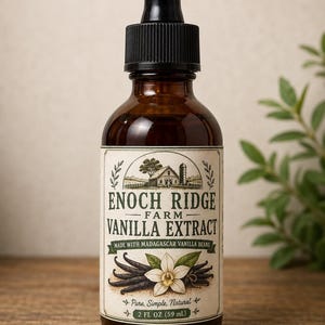 May include: A brown glass bottle with a black dropper cap containing Enoch Ridge Farm Vanilla Extract. The label features a farm illustration, a vanilla flower, and text stating Made with Madagascar Vanilla Beans and 2 FL OZ (59 ml).