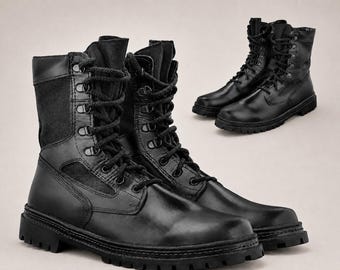 May include: A pair of black tactical combat boots featuring a smooth leather lower construction with fabric side panels, high-top ankle support, black laces, metal eyelets, and a thick, lugged rubber sole for traction and durability.