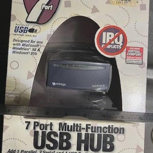 May include: A 7-port multi-function USB hub by Entrega. The packaging features the text "7 Port" and "USB HUB". The hub is designed to add parallel, serial, and USB ports to a PC or notebook. The product is designed for use with Microsoft Windows 98 & Windows 95b.