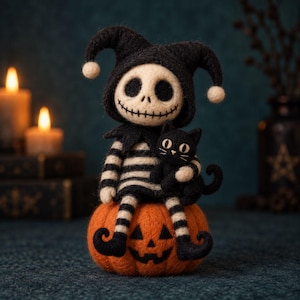 May include: A needle-felted figurine of a skeleton character wearing a black jester hat with white pom-poms and a black-and-white striped outfit. The character holds a small black cat and sits atop a round, orange felted pumpkin with a jack-o'-lantern face.