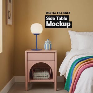 May include: A pink side table with an arched open shelf containing a wire basket, topped with a blue lamp and a yellow and blue striped jar. The text DIGITAL FILE ONLY Side Table Mockup is visible above the table against a mustard wall.