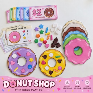 Puede incluir: Un set de juego imprimible de tienda de donas que incluye dinero de juguete ilustrado, tarjetas de pedido con el texto Donut Order #8, recortes de donas coloridas con varios ingredientes y pequeñas formas geométricas decorativas.