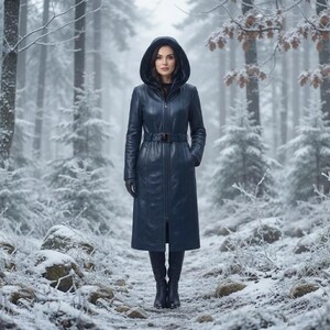 May include: A long, dark blue hooded coat with a textured snakeskin-like pattern, featuring a full-length front zip, a matching waist belt with a rectangular buckle, and long sleeves. The coat is paired with dark gloves and tall dark boots.