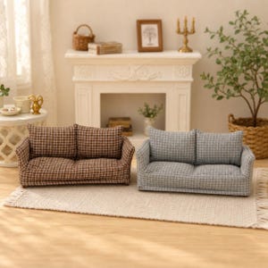 May include: Two miniature sofas placed side by side on a textured rug. One sofa features a brown and white grid pattern, while the other displays a grey and white grid pattern. Both pieces have two back cushions and low arms, designed for dollhouse decor.
