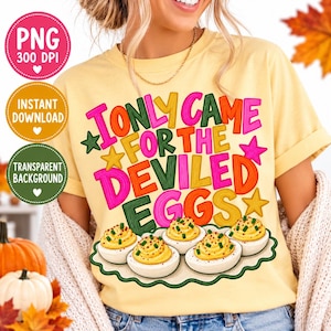 May include: A pale yellow t-shirt featuring the colorful text I ONLY CAME FOR THE DEVILED EGGS in pink, orange, yellow, and green. Below the text is a graphic of five deviled eggs garnished with green herbs on a scalloped white platter.