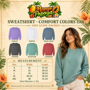May include: A size guide for Comfort Colors 1566 sweatshirts featuring a Mango Papaya Co logo, six color swatches including violet, white, blue jean, pepper, seafoam, and crimson, and a table listing measurements in inches for sizes S to 2XL.