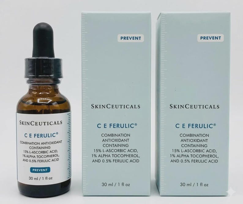May include: A brown glass dropper bottle and two light blue rectangular boxes of SkinCeuticals C E Ferulic combination antioxidant serum. Each label and box displays the text: 15% L-Ascorbic Acid, 1% Alpha Tocopherol, and 0.5% Ferulic Acid, 30 ml / 1 fl oz.