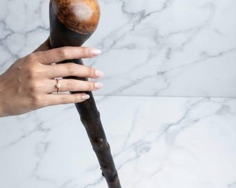 Bastón de madera artesanal, con empuñadura rústica y acabado en ébano.