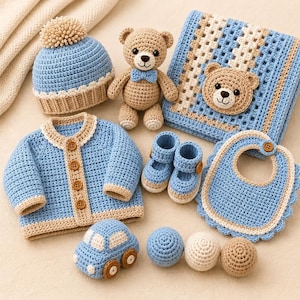 May include: A crochet set featuring a light blue and beige beanie with a pom-pom, a teddy bear with a blue bow tie, a square blanket with a bear face, a button-up cardigan, booties, a bib, a toy car, and three small textured crochet balls.