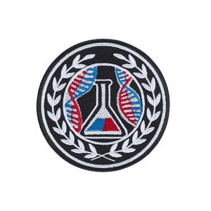 May include: A circular embroidered patch featuring a black background with a white border. The center displays a white laboratory flask with blue and red liquid, flanked by two DNA strands in red and blue. A white laurel wreath encircles the design.